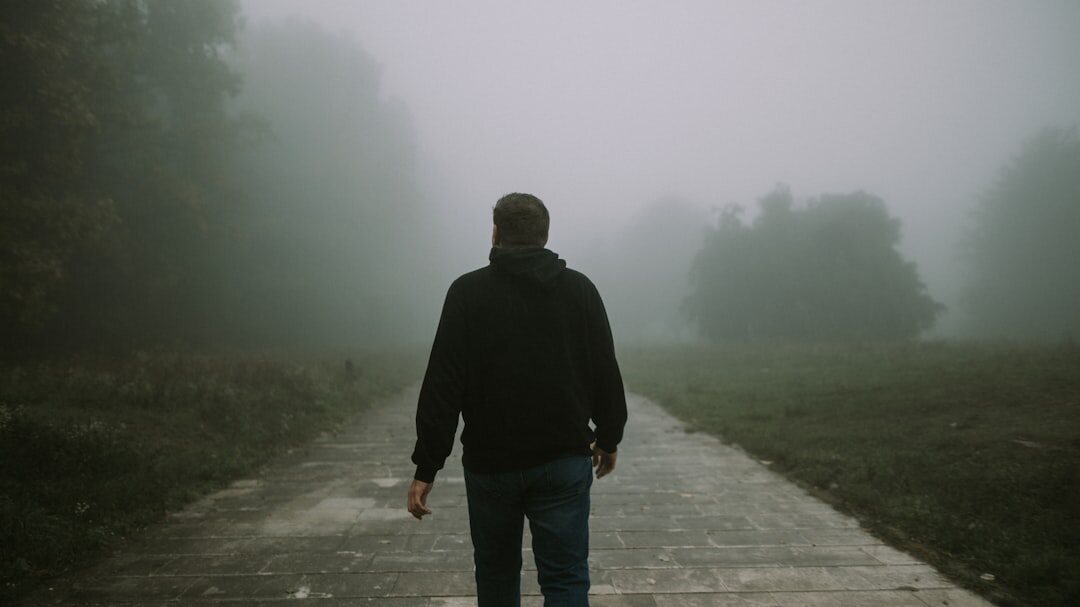 man walking in fog