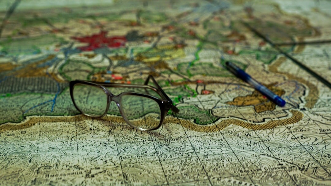 Magnifying glass resting on an old handwritten letter and map